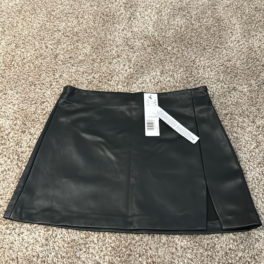 Topshop faux leather black mini skirt with slit. US 4. Brand new with tags